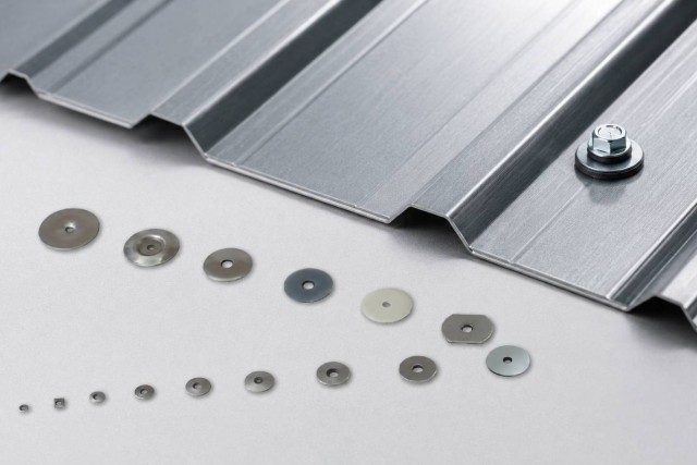Bonded sealing washers installed on a metal roofing panel to prevent leakage around screw holes